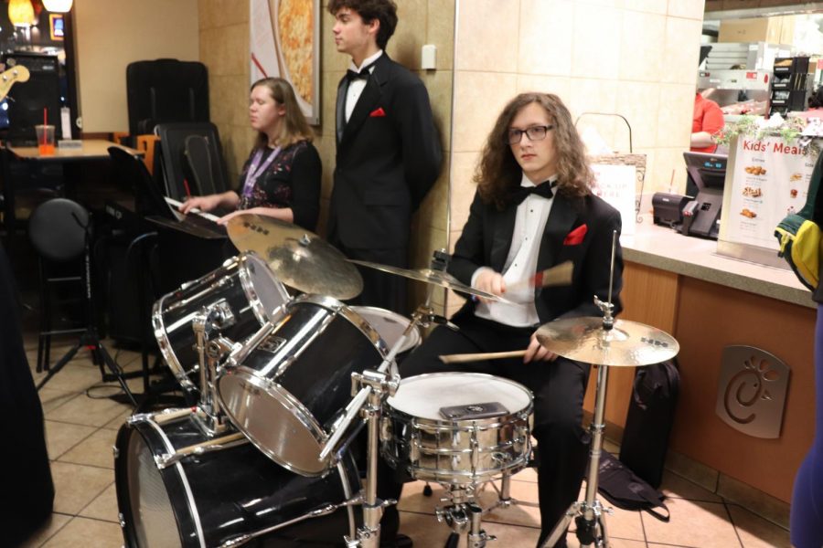 Junior Christpher Moore plays the drumset. “Chick-Fil-A night is a fun experience that helps the choir out a lot,it is also a huge fundraiser for us,” Moore said. Photo by Cora Bennett
