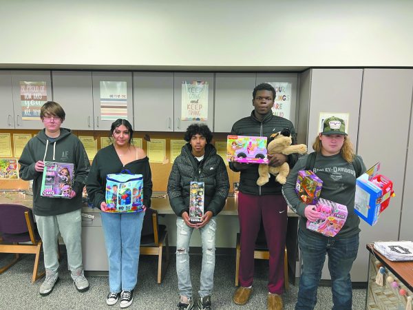 Giving back. Presenting their toys for the Salvation Army’s Angel Tree project are (left to right) junior Bryce Robalik, junior Maraiah Ramos, junior Enyce Jenkins, junior Isaac Elmamoun, and senior Joseph O’Shea.The AngelTree campaign was started by East’s Leadership Academy, and JAG students wanted to help. Students take a tag from a small tree in each classroom to purchase a gift for children in need.“We used this as our opportunity for a community service project,” JAG representative Brianne Healy said.