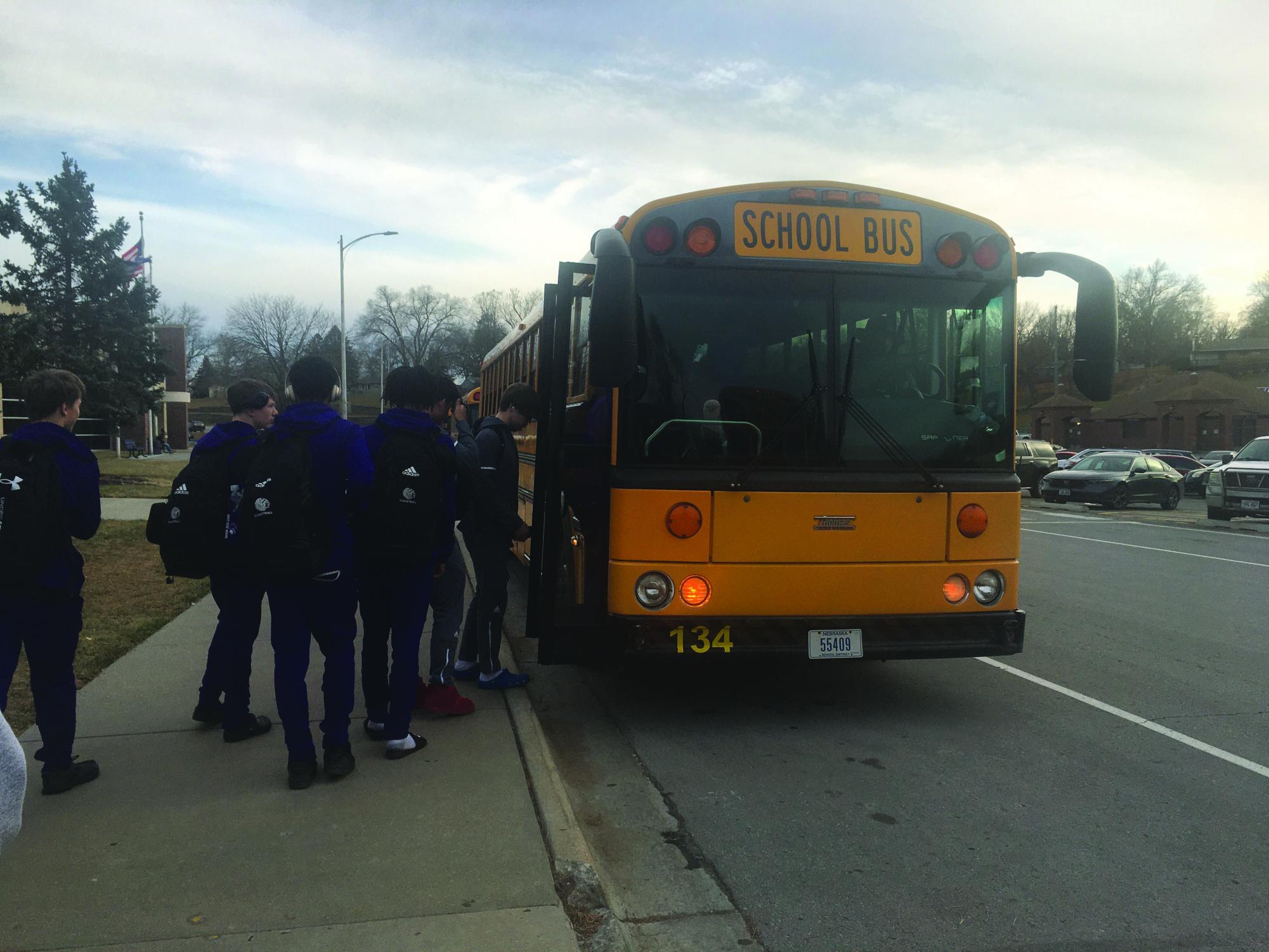 On the road. Members of the Bellevue East boys basketball team board bus 134. Buses are made to keep passengers safe, but for bus driver Dave Aiken, it also helps to be quiet while he’s driving. “Kind of a general rule, just for people who are riding, is to use a lot of courtesy and try to keep the voices and stuff down,” Aiken said. 