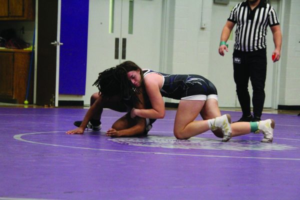 Pin her Down, During the Black and Purple scrimmage dual on Nov. 29, sophomore Makaela Davis, in purple, competes against fellow teammate senior Ally Cook, in black. The scrimmage was used to fundraise snacks fro teh girls wrestling team.  “Wrestling seniors is scary,” Davis said. 