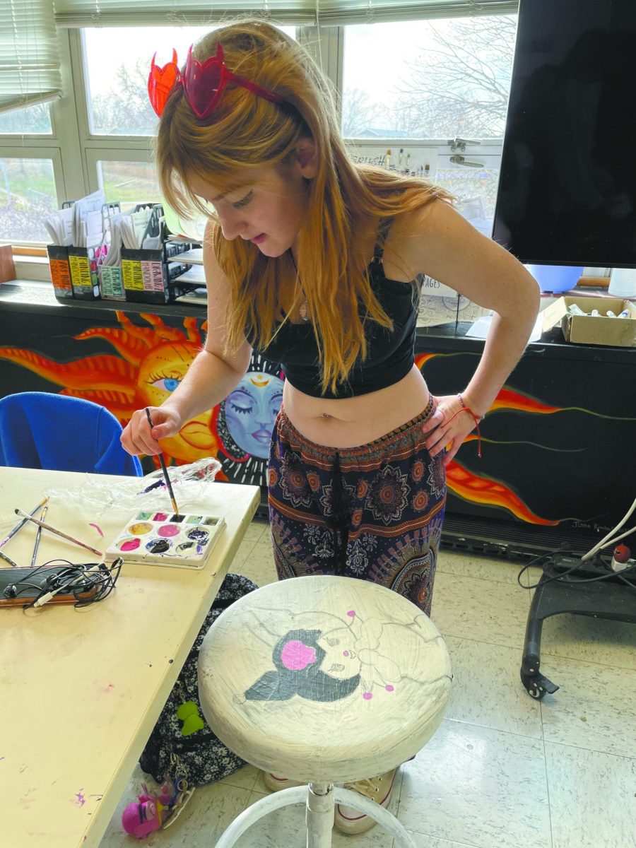 Get creative. In painting class, sophomore Silver Hagan uses her artistic talent by painting a stool. “I think that taking art in school will make me better and I think it’ll help me for the future when I want to continue doing art,” Hagan said. 
