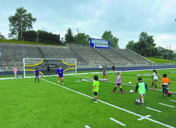 Bam! Another kick is delivered from a young child practicing soccer.  Elementary children were scattered all around trying to kick the ball, as high school athletes told them what to do. “We normally get the littles involved with that,” coach Laura Heath said.